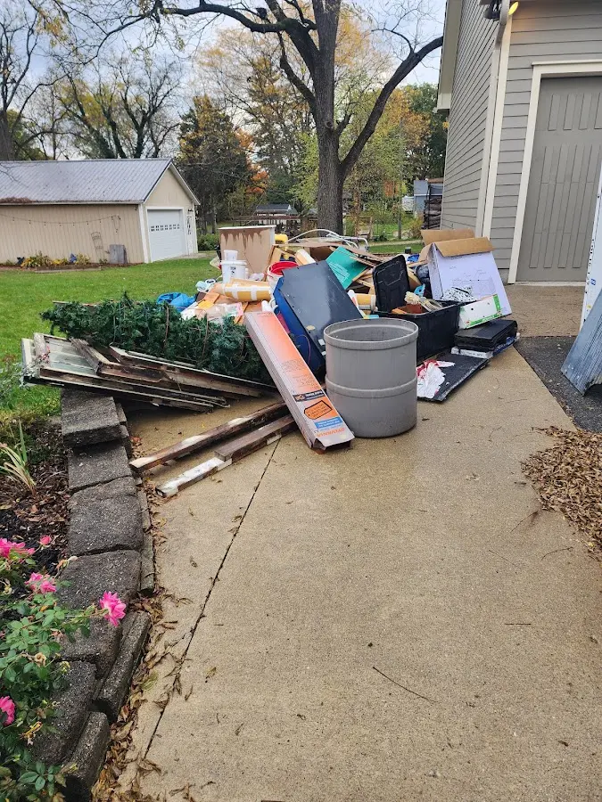 Dumpster being loaded with debris for Roofing Dumpster Rental in Somerville